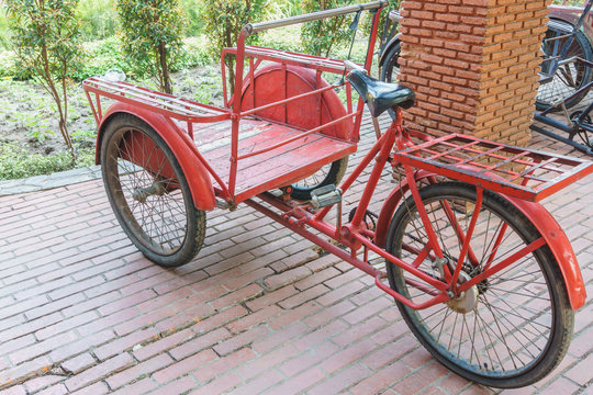 red trishaw for transportation in parking