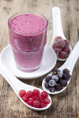 Smoothies from frozen black currant, red currant and gooseberry