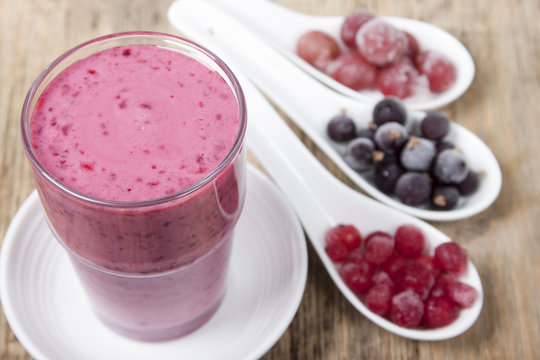 Smoothies from frozen black currant, red currant and gooseberry