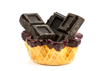 Pieces of chocolate inside a porcelain cup isolated on white bac