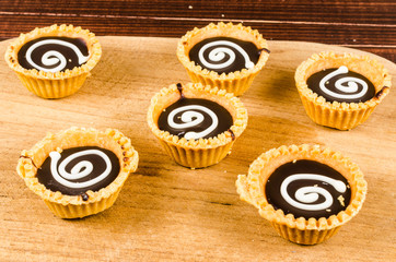 Chocolate tart on wooden board