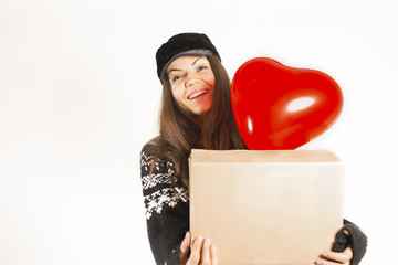 Smiling woman with parcel box and red heart shaped balloon
