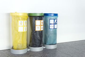 Three trash cans for recycling