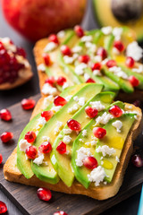 Avocado sandwich with feta and pomegranate