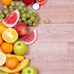 Fruits and vegetables on a wooden background