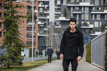 Stylish Young Handsome Man in Black Coat Standing in City