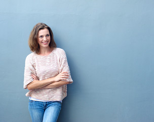 Smiling mid adult woman standing with arms crossed