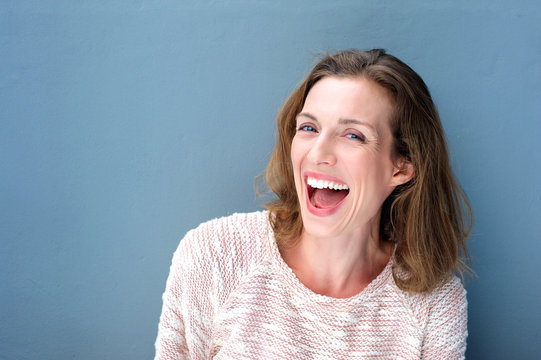 Happy beautiful fresh mid adult woman laughing
