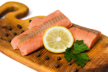 Raw salmon fillet with lemon, black pepper and parsley