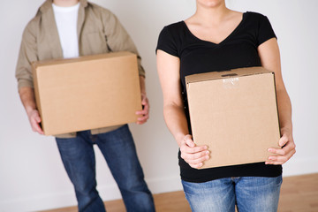 Moving: Anonymous Couple Each Holding A Box