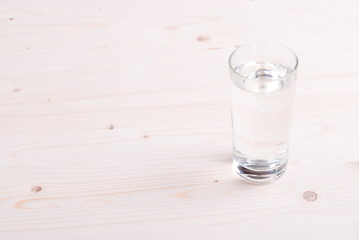 water in a glass and a napkin on the board