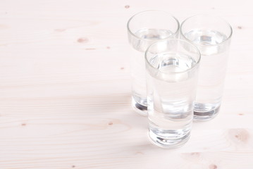 water in a glass and a napkin on the board