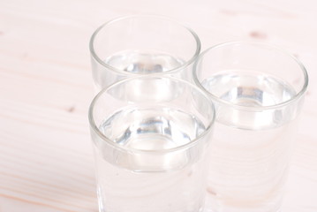 water in a glass and a napkin on the board