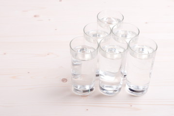 water in a glass and a napkin on the board
