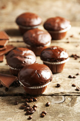 Tasty homemade chocolate muffins on wooden table