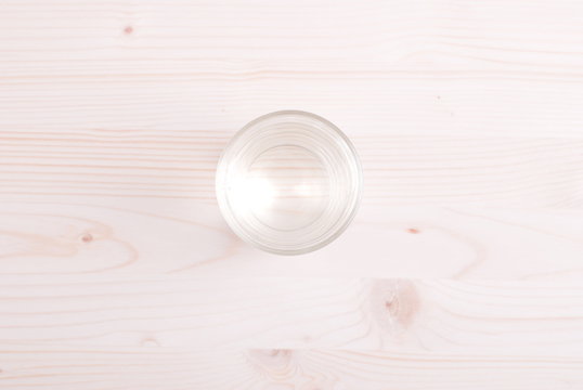 water in a glass and a napkin on the board