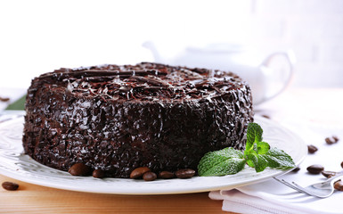 Tasty chocolate cake with mint on table close up