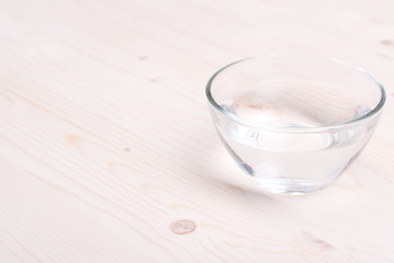 water in a glass and a napkin on the board