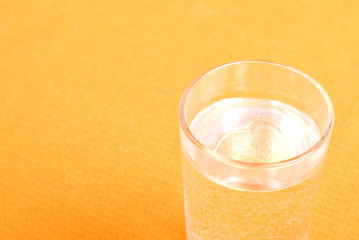 water in a glass and a napkin on the board