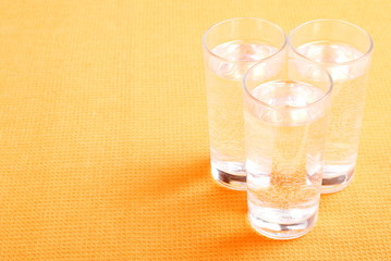 water in a glass and a napkin on the board