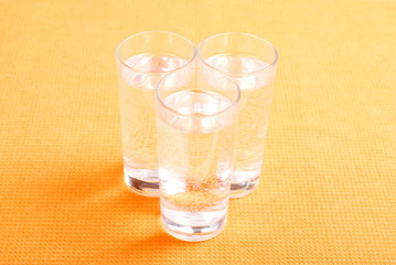 water in a glass and a napkin on the board