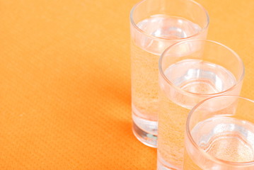 water in a glass and a napkin on the board