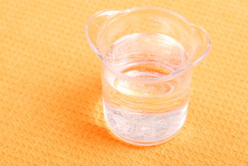 water in a glass and a napkin on the board