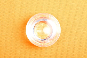 water in a glass and a napkin on the board