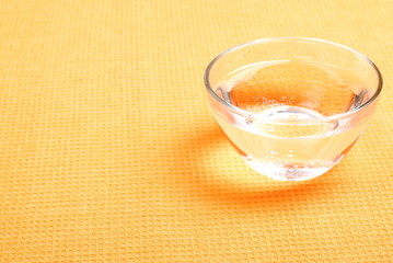 water in a glass and a napkin on the board