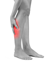 Woman massaging her painful leg calf.