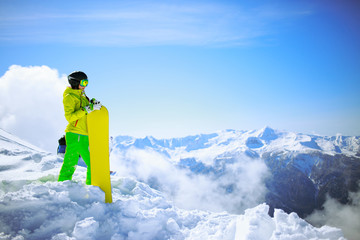 snowboarder against sun and mountains