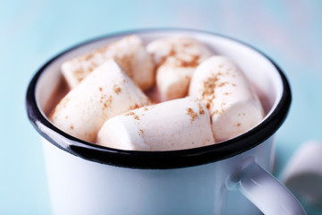 Fototapeta na wymiar Mug of cocoa with marshmallows on wooden table, closeup