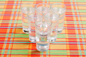 water in a glass and a napkin on the board