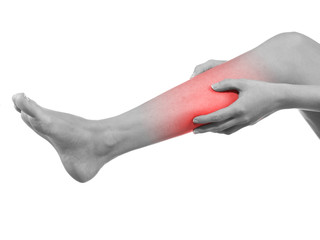 Woman massaging her painful leg calf.