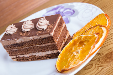 Chocolate cake with strawberry on wooden table close-up