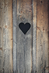 Obraz na płótnie Canvas Heart cut out the wood