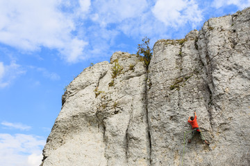Rock climber on limestone rock near Krakow, Poland