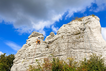 Rock climber on limestone rock near Krakow, Poland