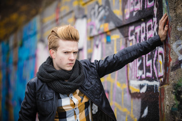 Fashion male portrait on graffiti wall