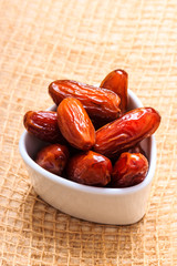 dried dates in bowl on table background
