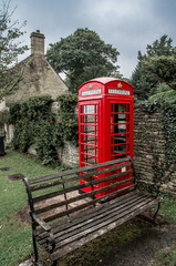 Typical red English telephone booth in Bibury Village