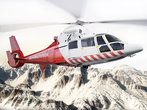 Rescue helicopter in flight over snow capped mountains