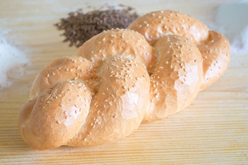 Bread with sesame on wooden table