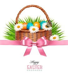 Happy Easter background. Basket with eggs, daisies, grass and a