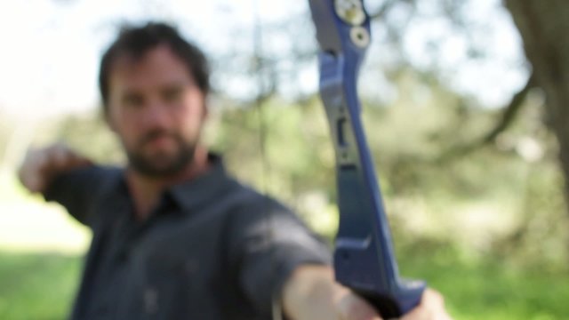 Archer viewed from the front with focus on the arrow tip.  Clip doesn't change focus.