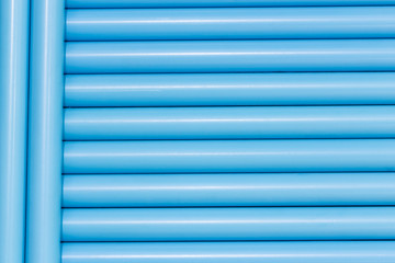 Blue pvc pipes in line for background texture
