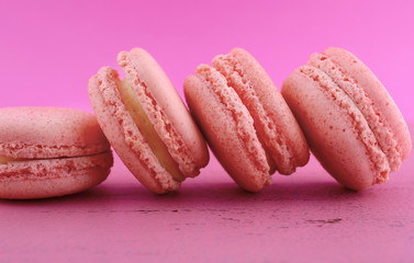 Strawberry flavor macaroons on pink background