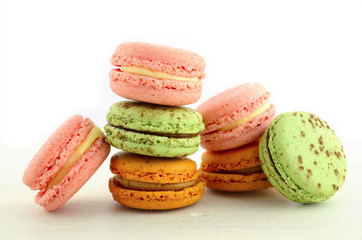 Colorful macaroons on white wood table.