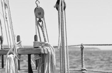 Sailboat at sea ropes, pulleys and rigging detail in monochrome