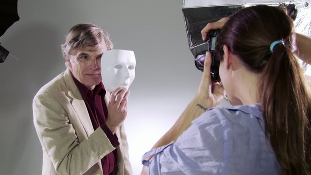 Photographer captures images of the actor/celebrity behind the mask.  Edgy, hand-held camera in studio.